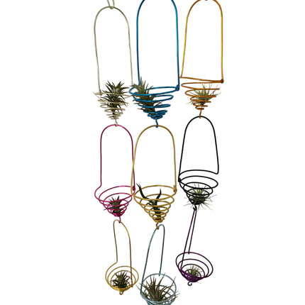 Decorative wall art with colorful metal sculptures and air plants 